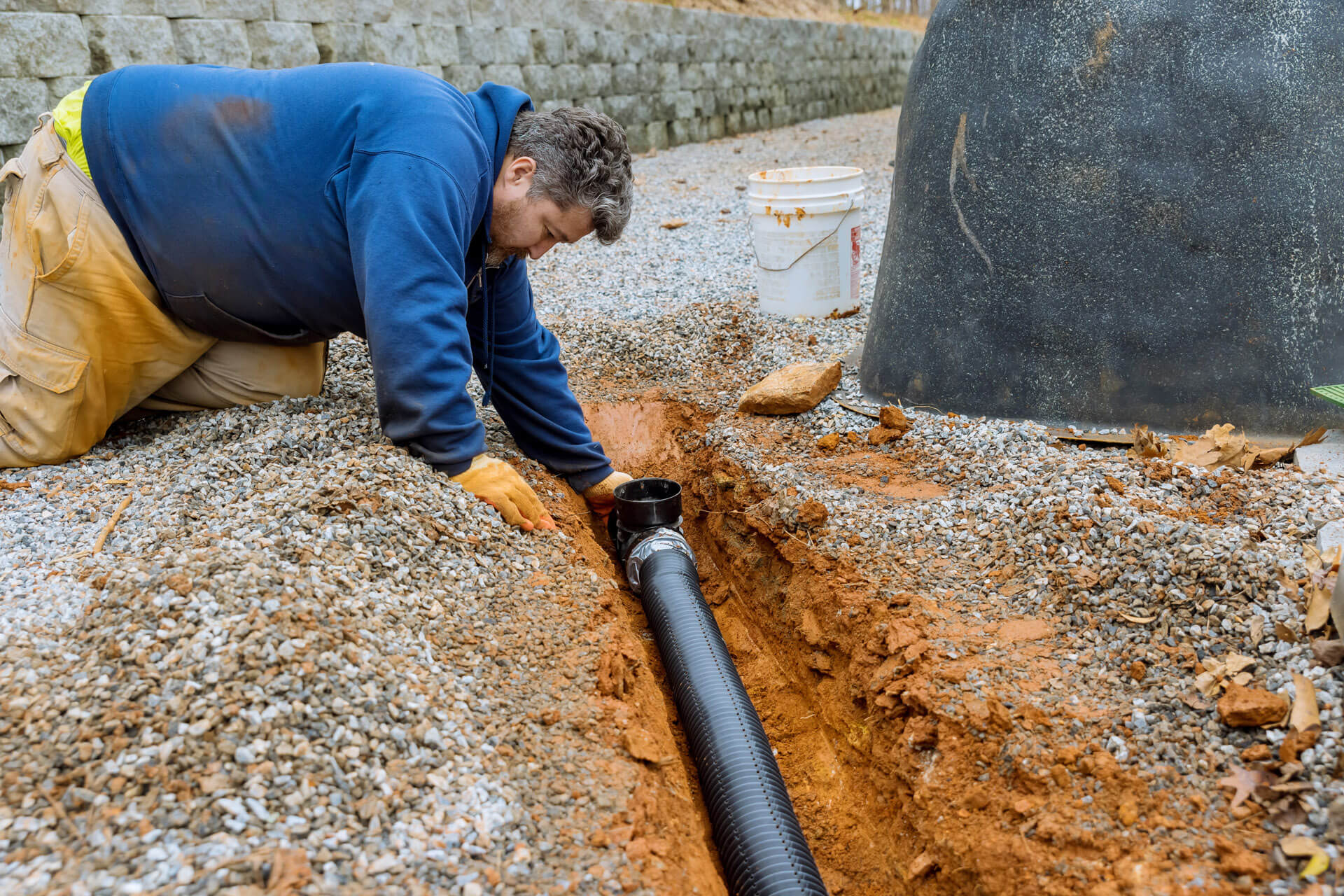A Carolina Heating Service technician inspecting an exposed water line - Carolina Heating Service Inc. A Carolina Heating Service technician inspecting an exposed water line