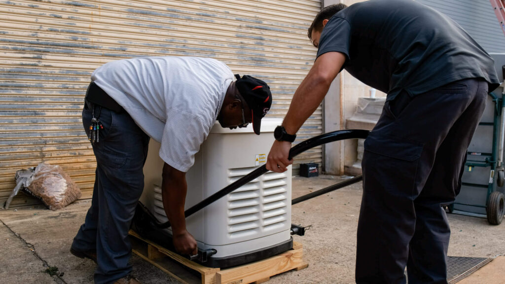 Two Carolina Heating Service technicians installing a generator - Carolina Heating Service Inc. Two Carolina Heating Service technicians installing a generator